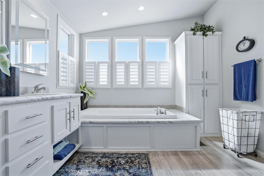 500 Atascadero Road Morro Bay, CA 93442 - Photo 22 of 37 a bathroom with a double vanity sink a mirror a bathtub and window