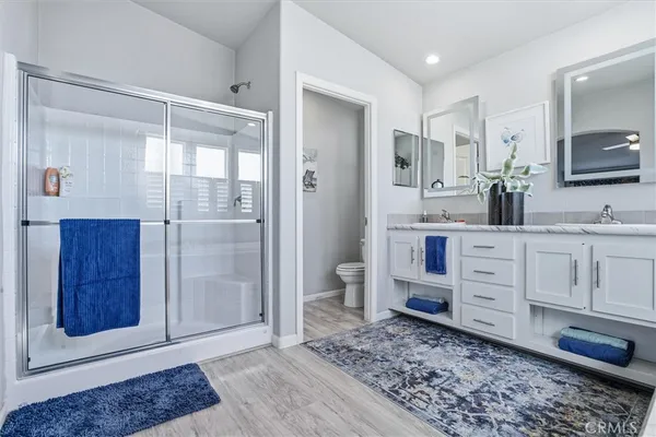 a bedroom with a bed a dresser and a window