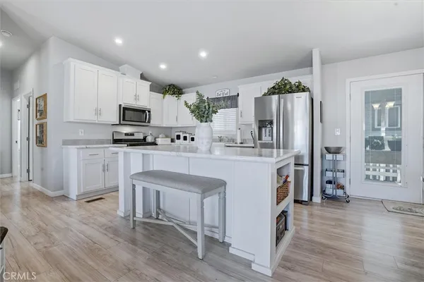 a kitchen with a sink microwave and cabinets
