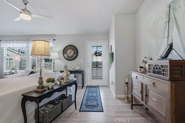 a living room with furniture a flat screen tv and a large window