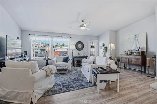 a living room with furniture and a view of kitchen