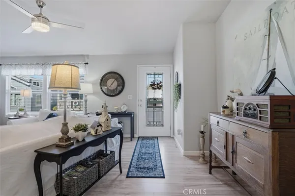 a living room with furniture a flat screen tv and a large window