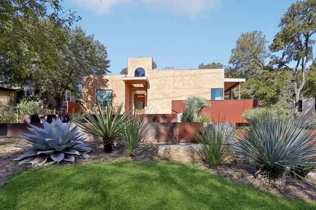 a view of a house with wooden fence