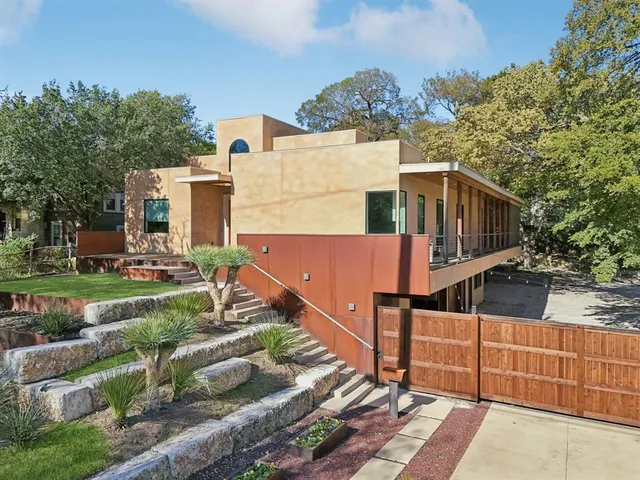 a view of a house with wooden fence