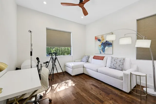 a view of a backyard with plants and chairs