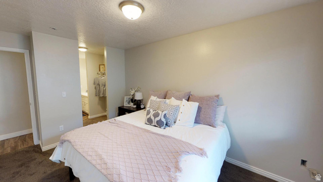 856 East 300 South Provo, UT 84606 - Photo 6 of 9 Bedroom featuring dark carpet, a textured ceiling, and ensuite bathroom