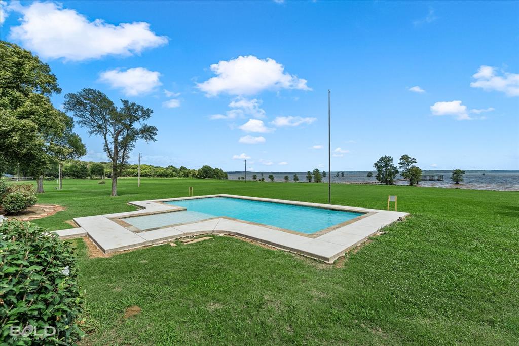 10099 Ferry Lake Road Oil City, LA 71061 - Photo 3 of 14 Resort-style backyard overlooking beautiful Caddo Lake