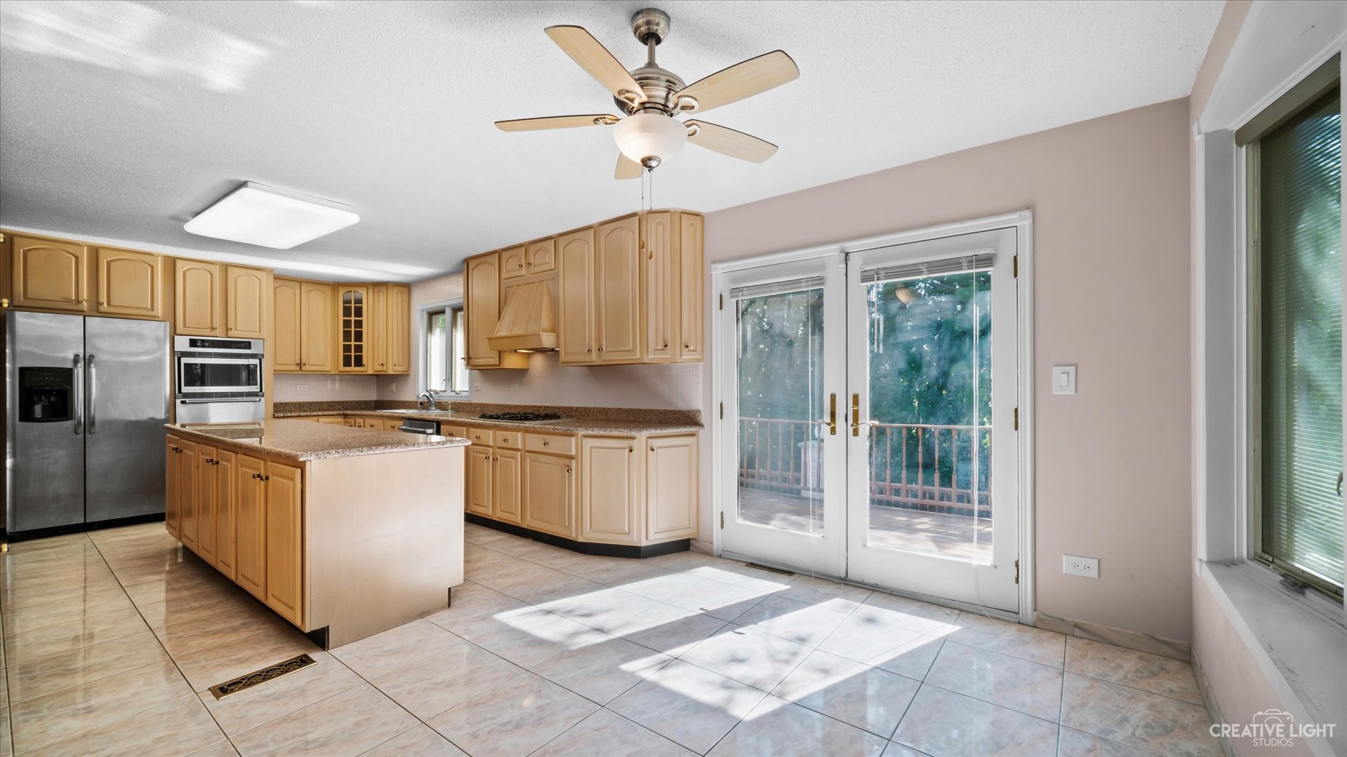 30W400 Army Trail Road Wayne, IL 60184 - Photo 12 of 30 a kitchen with stainless steel appliances granite countertop a stove a sink and a refrigerator