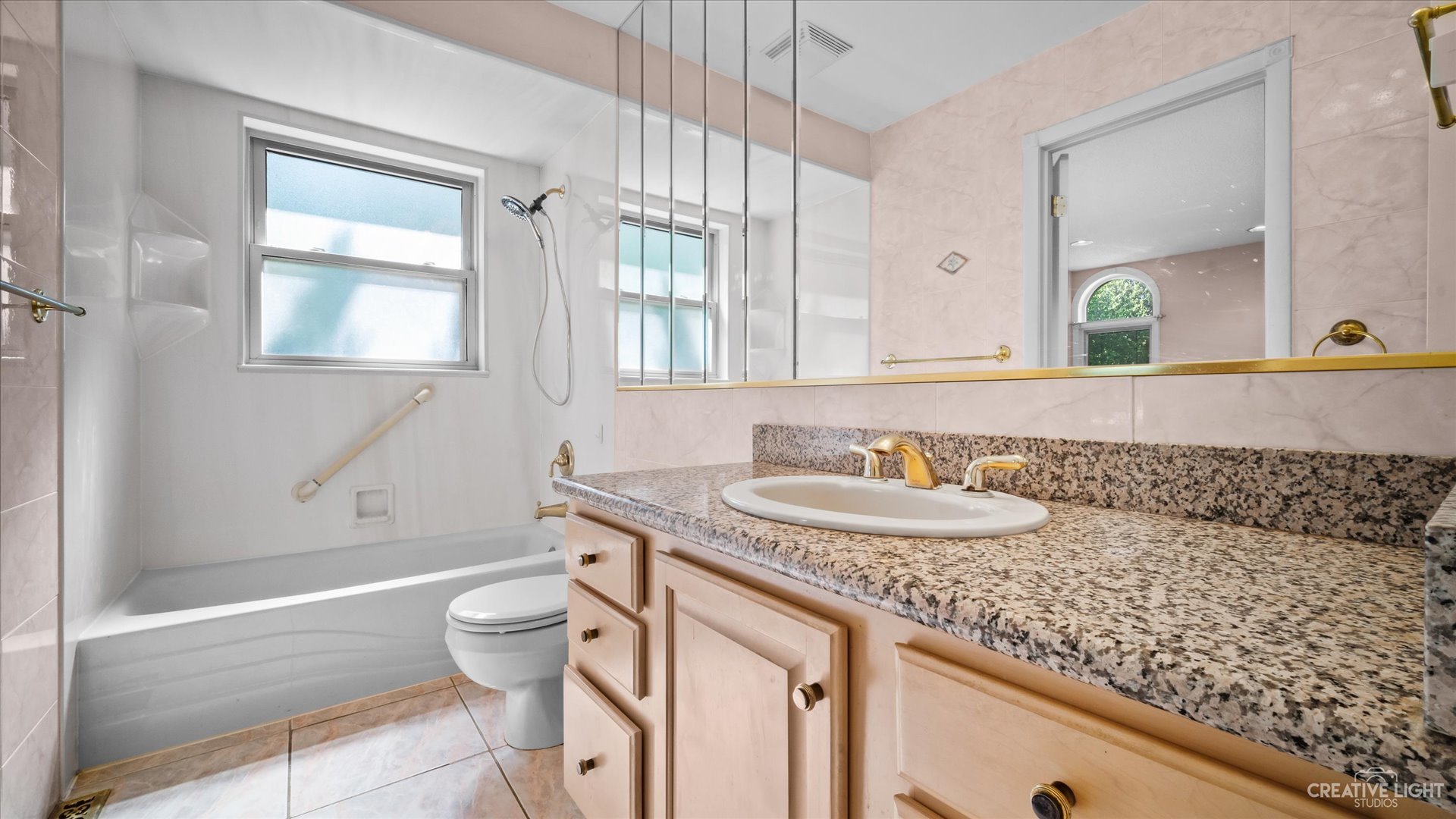 30W400 Army Trail Road Wayne, IL 60184 - Photo 16 of 30 a bathroom with a granite countertop sink a toilet a mirror and bathtub