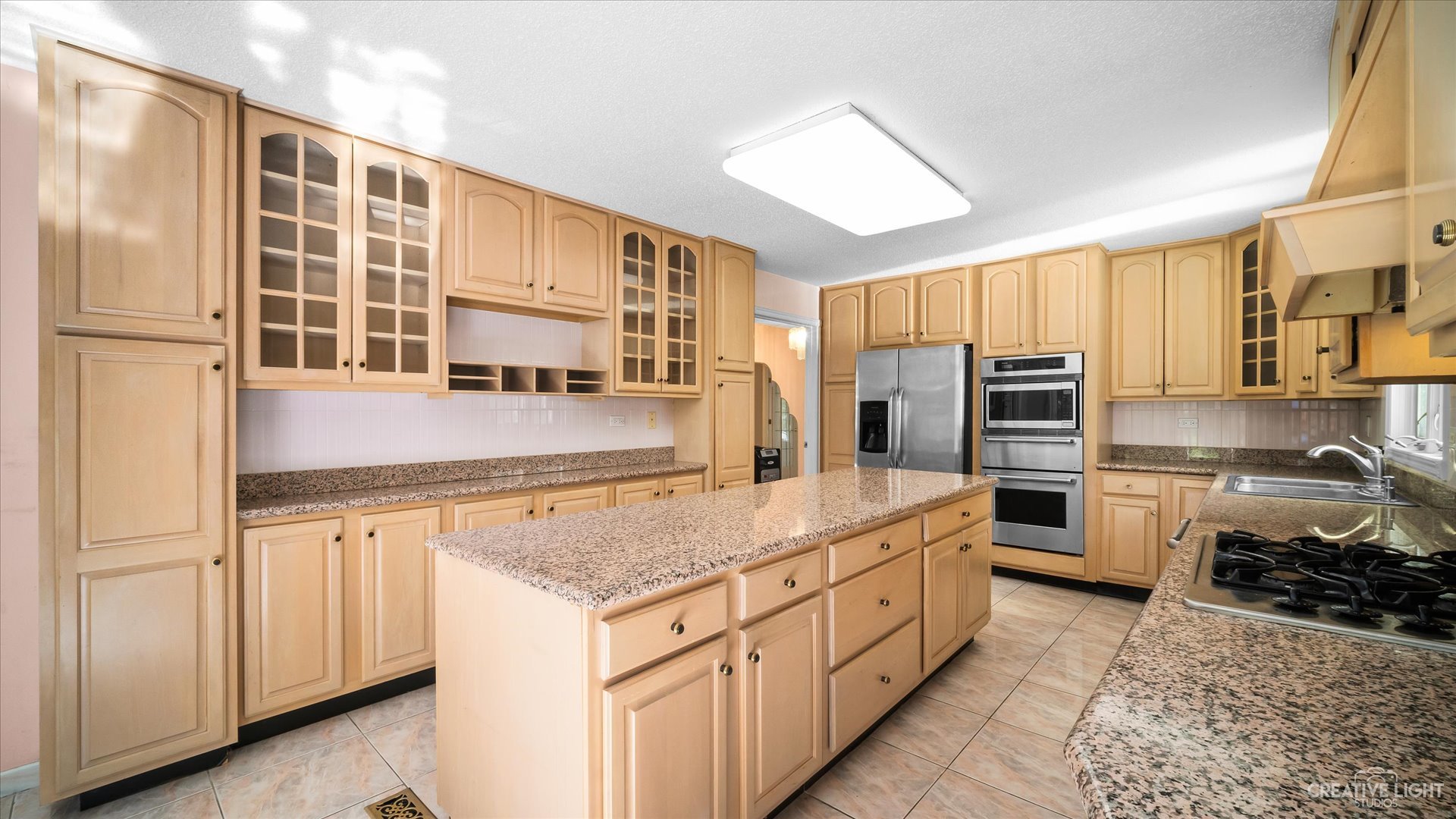 30W400 Army Trail Road Wayne, IL 60184 - Photo 9 of 30 a kitchen with stainless steel appliances granite countertop a stove and a refrigerator