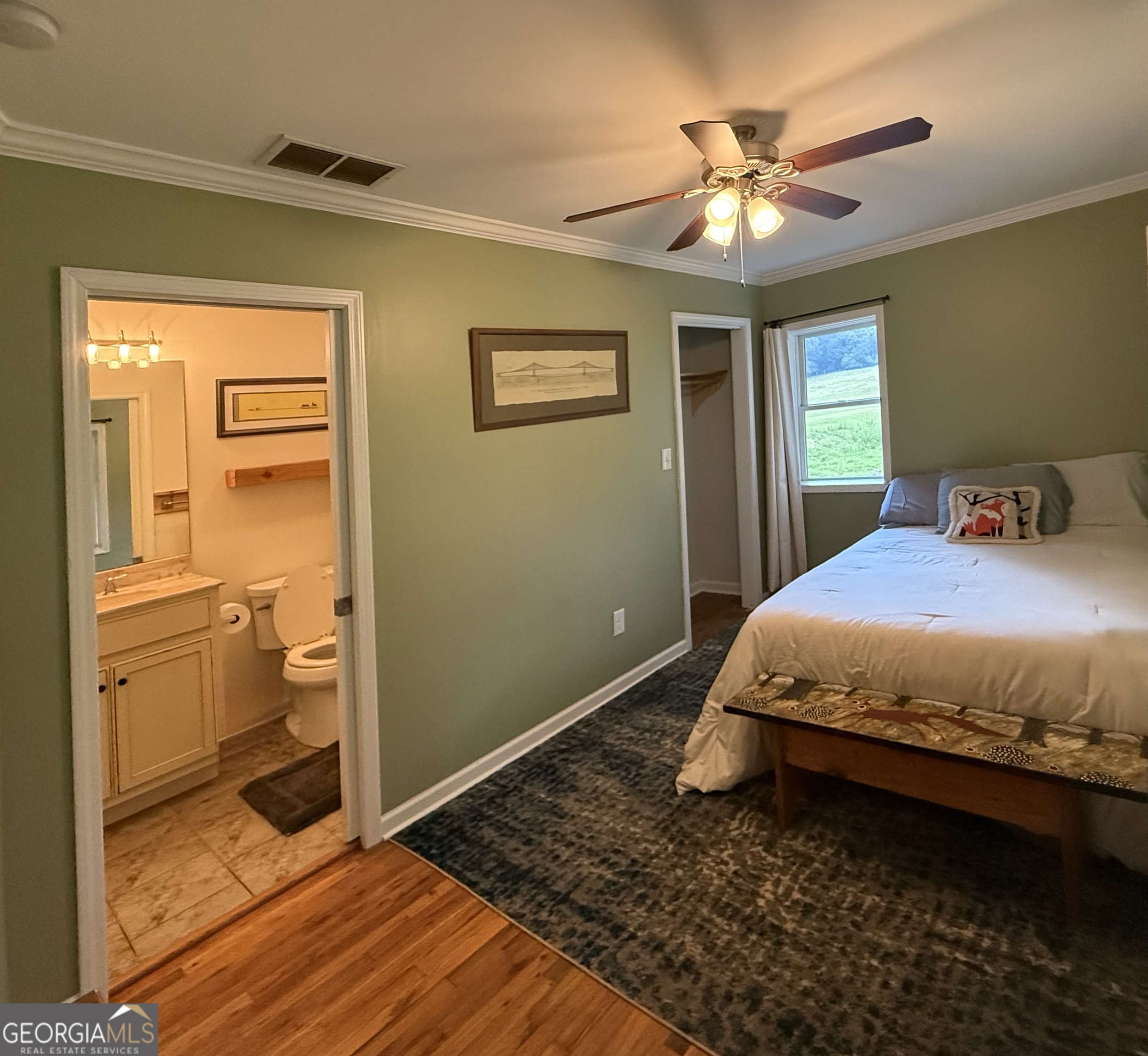 1191 Aderhold Rogers Road Commerce, GA 30530 - Photo 11 of 30 a bedroom with a bed and a chandelier