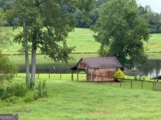1191 Aderhold Rogers Road Commerce, GA 30530 - Photo 11 of 33 a view of lawn chairs and table in the garden