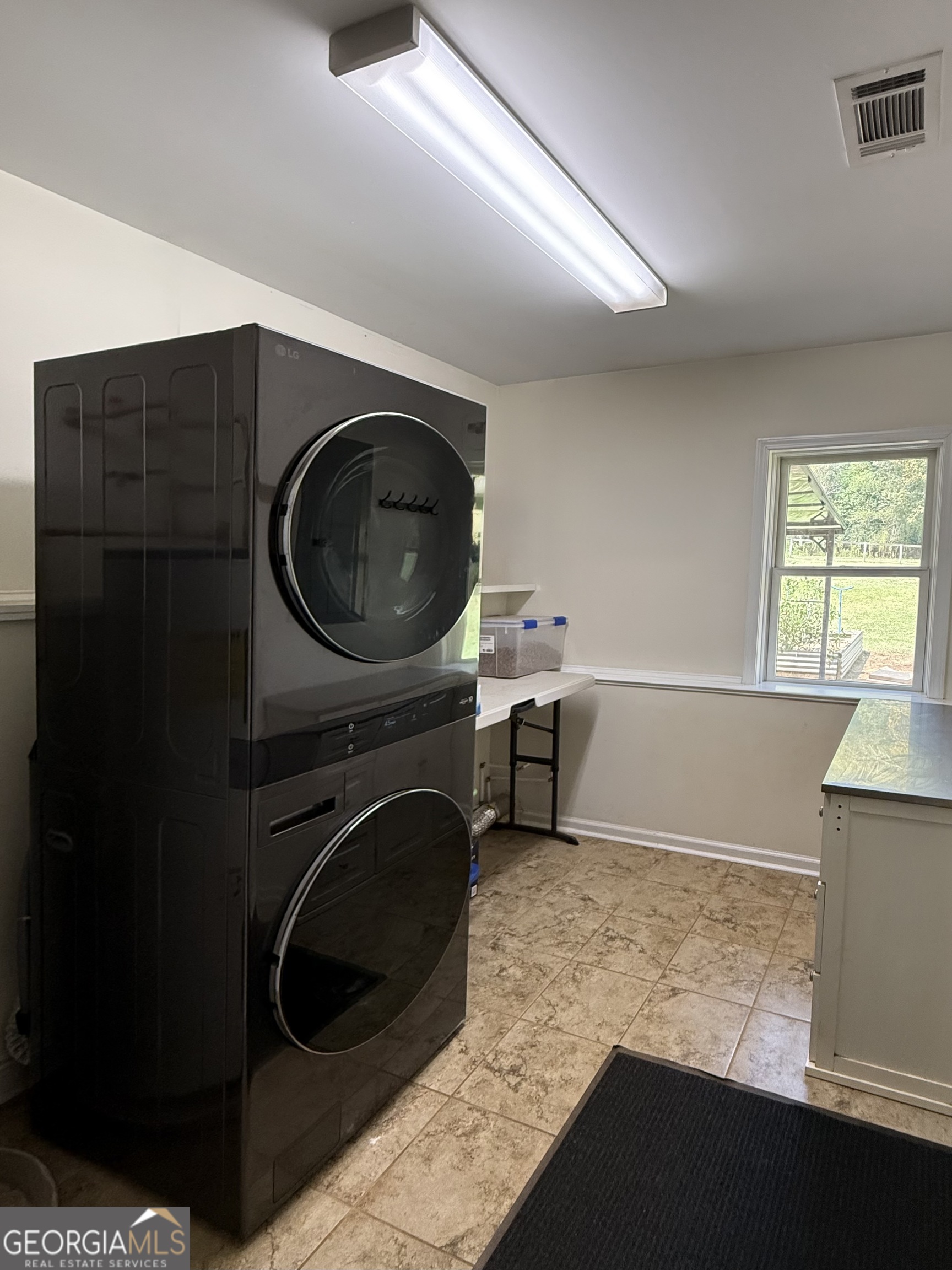 1191 Aderhold Rogers Road Commerce, GA 30530 - Photo 16 of 30 a room with a washer and dryer