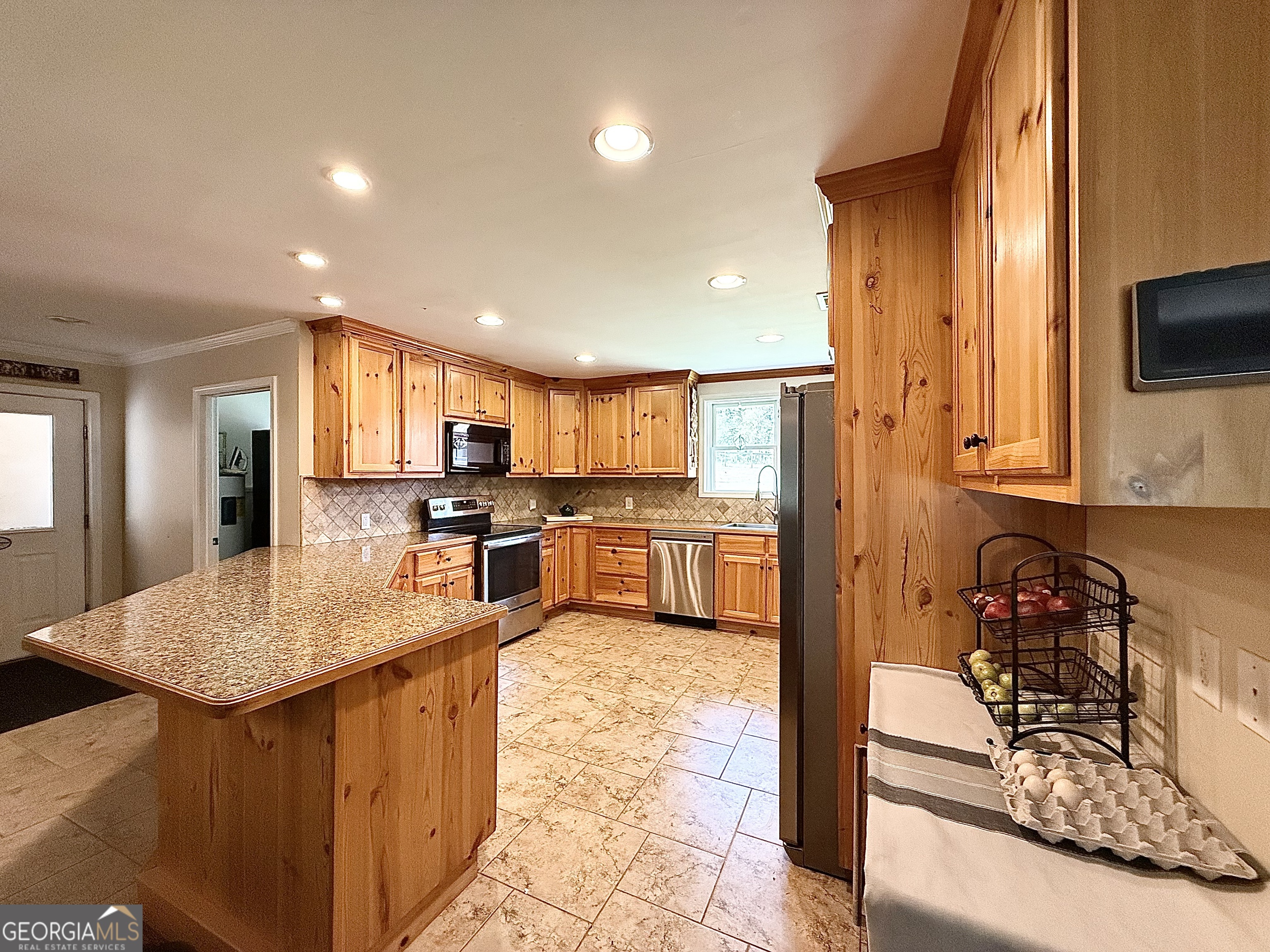 1191 Aderhold Rogers Road Commerce, GA 30530 - Photo 2 of 30 a kitchen with stainless steel appliances granite countertop a sink counter space and cabinets