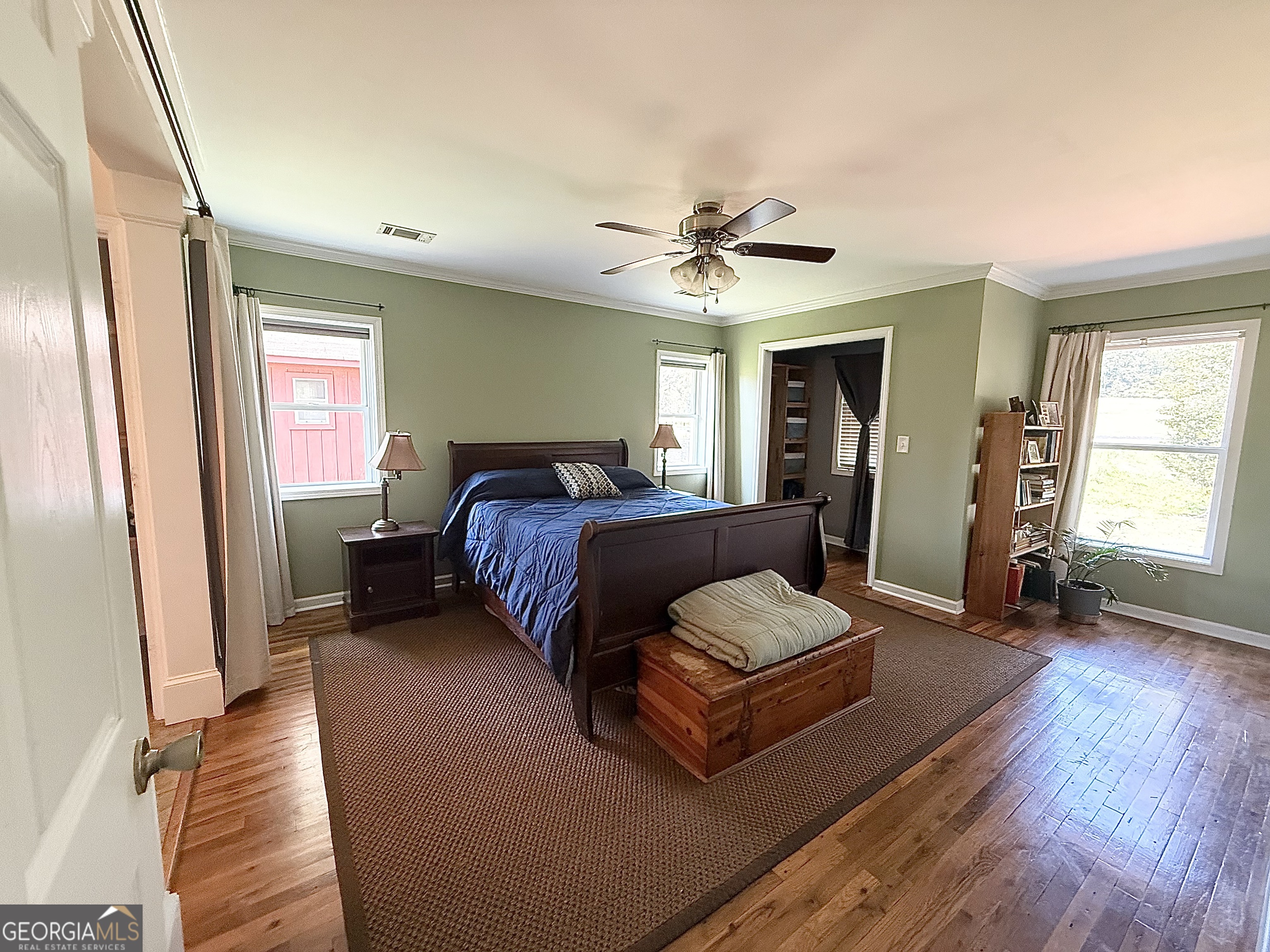 1191 Aderhold Rogers Road Commerce, GA 30530 - Photo 22 of 33 a spacious bedroom with a bed and a chandelier