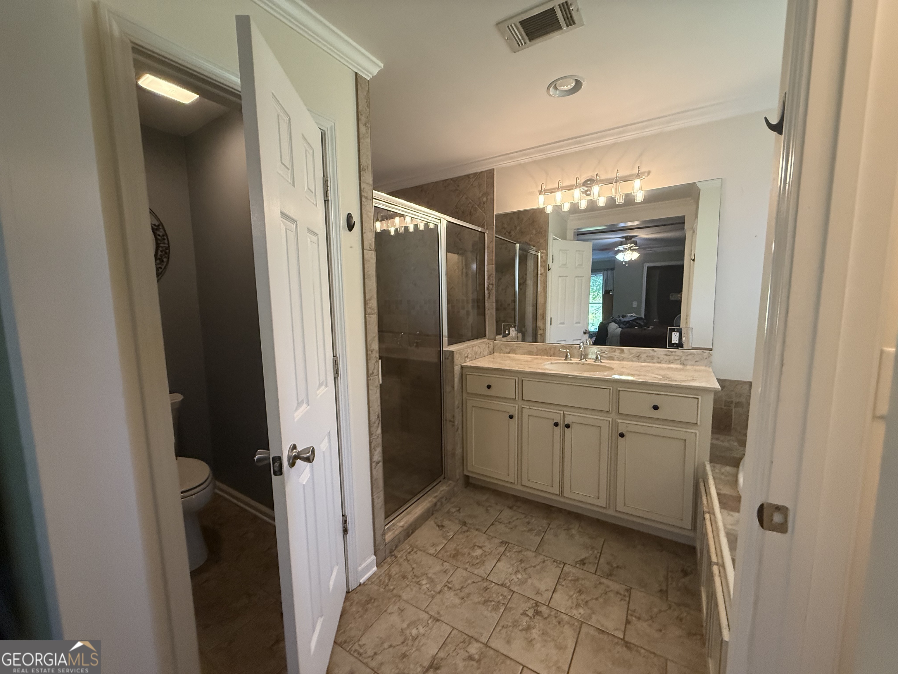 1191 Aderhold Rogers Road Commerce, GA 30530 - Photo 26 of 33 a bathroom with a granite countertop sink mirror and toilet