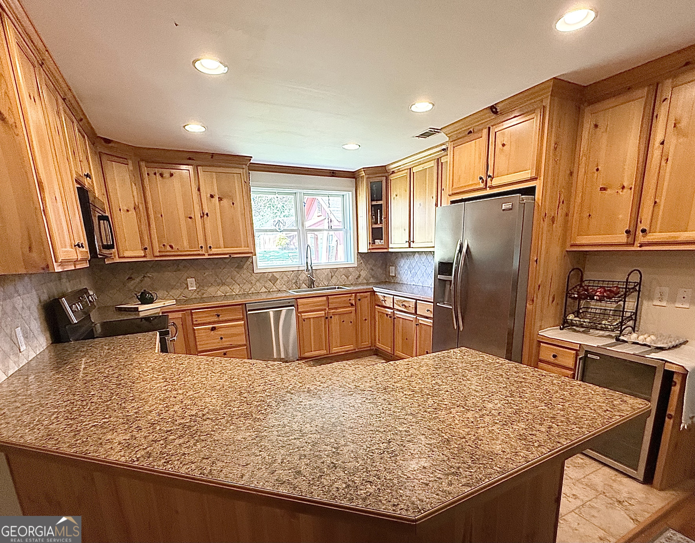 1191 Aderhold Rogers Road Commerce, GA 30530 - Photo 3 of 30 a kitchen with stainless steel appliances granite countertop a sink refrigerator and cabinets