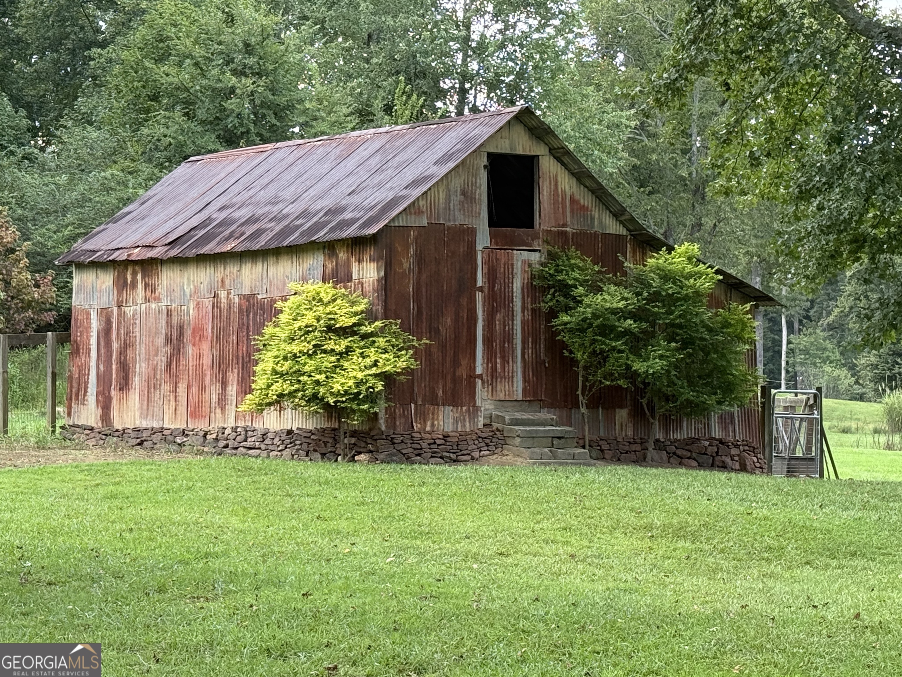 1191 Aderhold Rogers Road Commerce, GA 30530 - Photo 10 of 33 a backyard of a house with lots of green space
