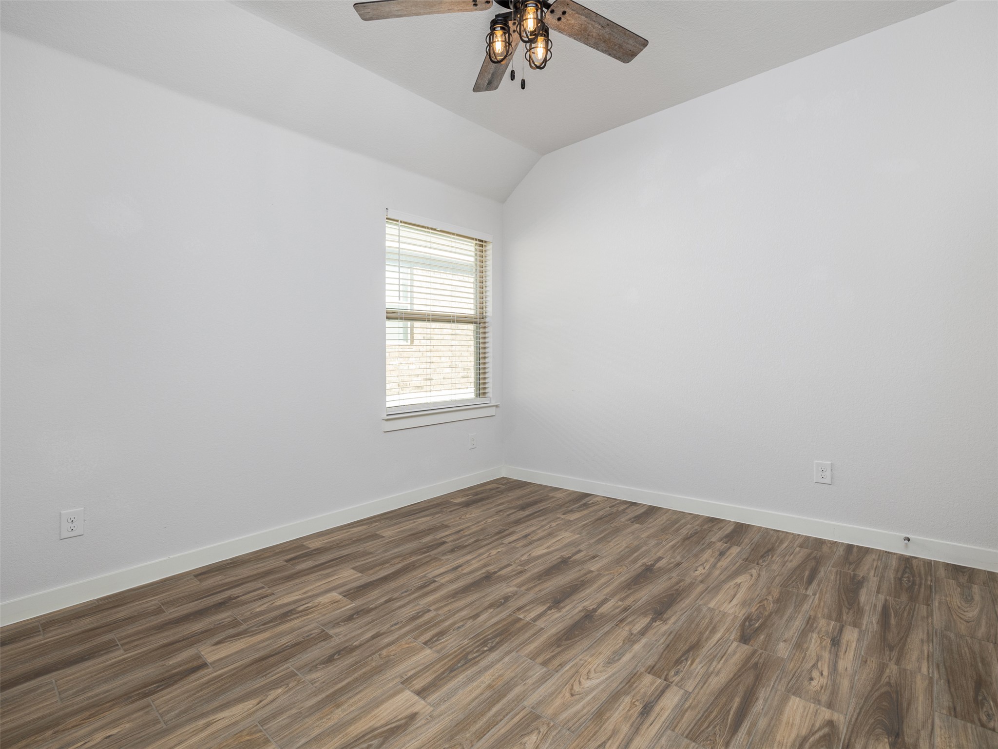 6856 Catania Loop Round Rock, TX 78665 - Photo 21 of 30 Spare room with lofted ceiling, dark wood-style floors, and ceiling fan