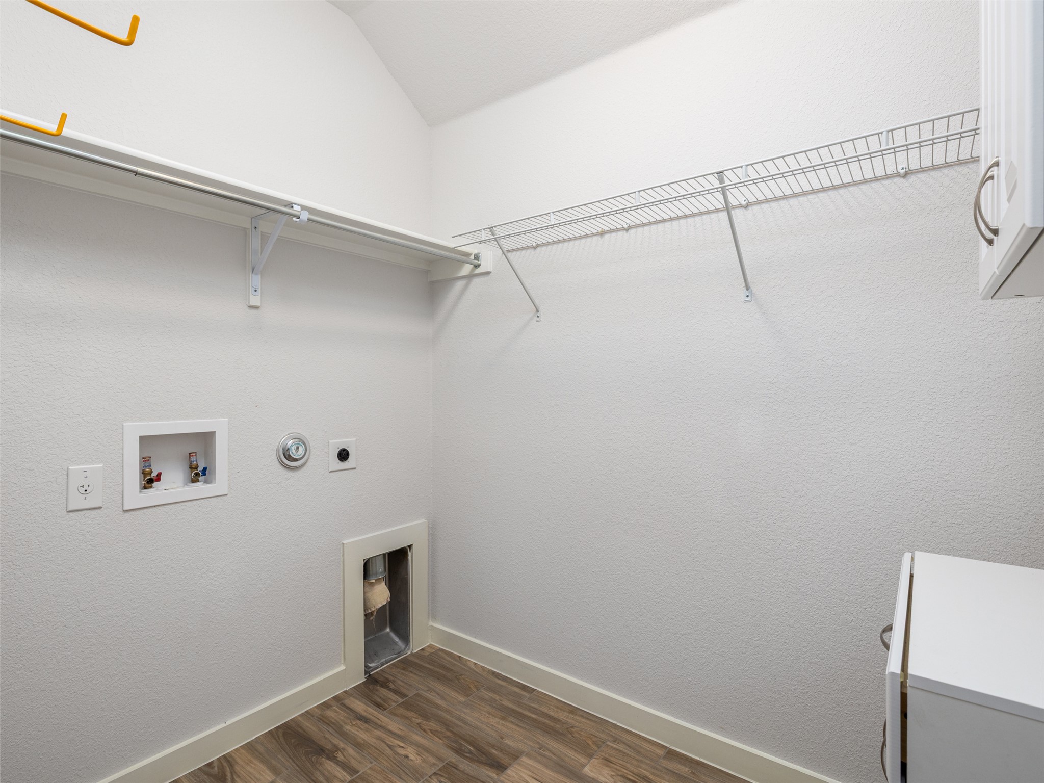 6856 Catania Loop Round Rock, TX 78665 - Photo 24 of 30 Laundry area with dark wood-type flooring, hookup for a washing machine, hookup for an electric dryer, gas dryer hookup, and a textured wall
