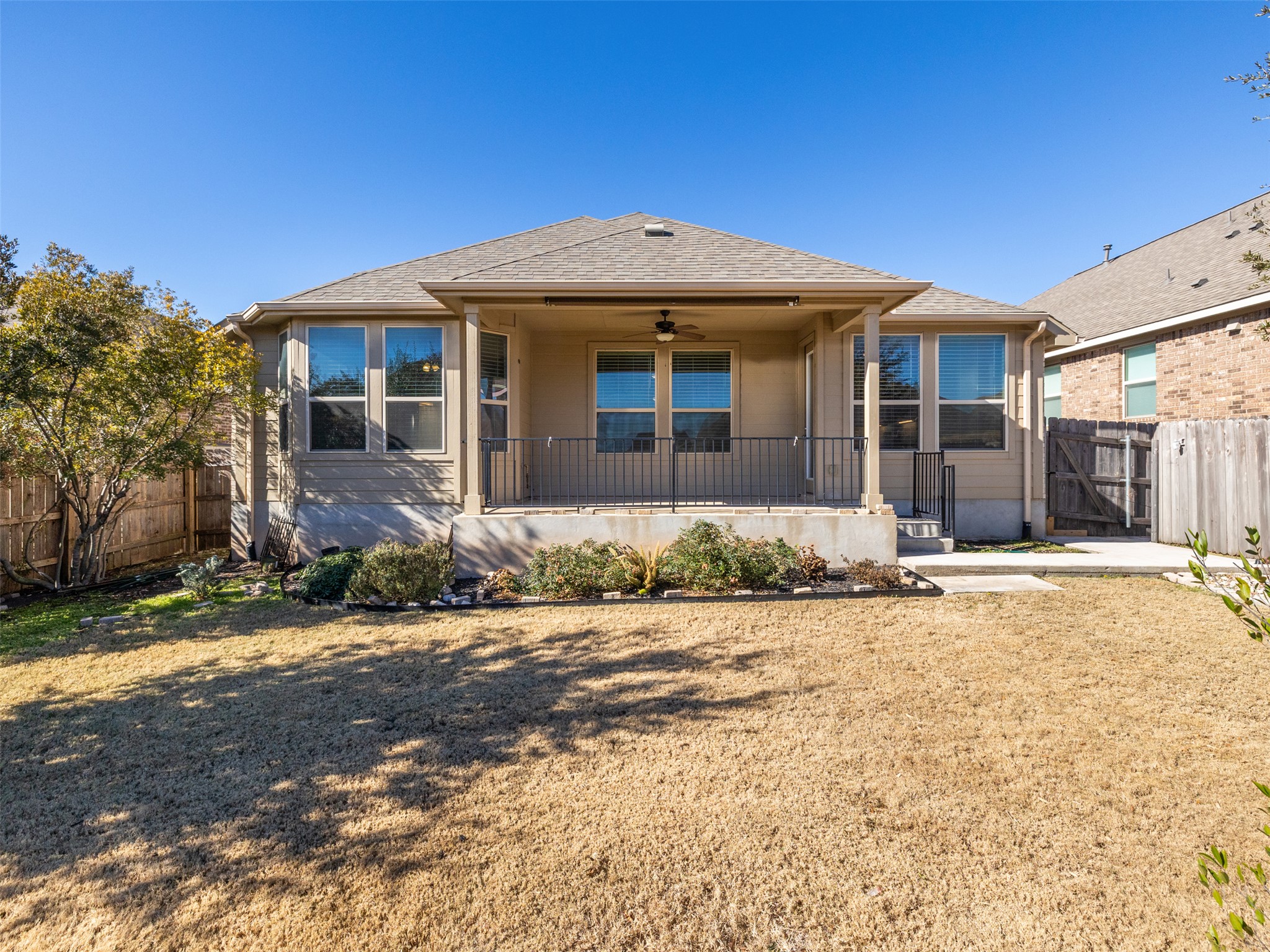 6856 Catania Loop Round Rock, TX 78665 - Photo 28 of 30 Rear view of property featuring a fenced backyard, a ceiling fan, a gate, and a shingled roof