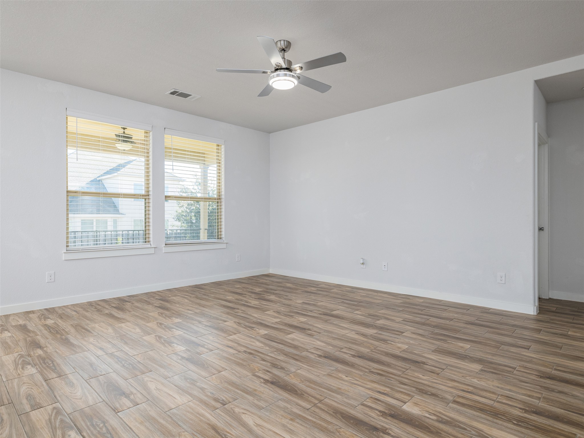 6856 Catania Loop Round Rock, TX 78665 - Photo 8 of 30 Unfurnished room featuring wood finish floors and ceiling fan
