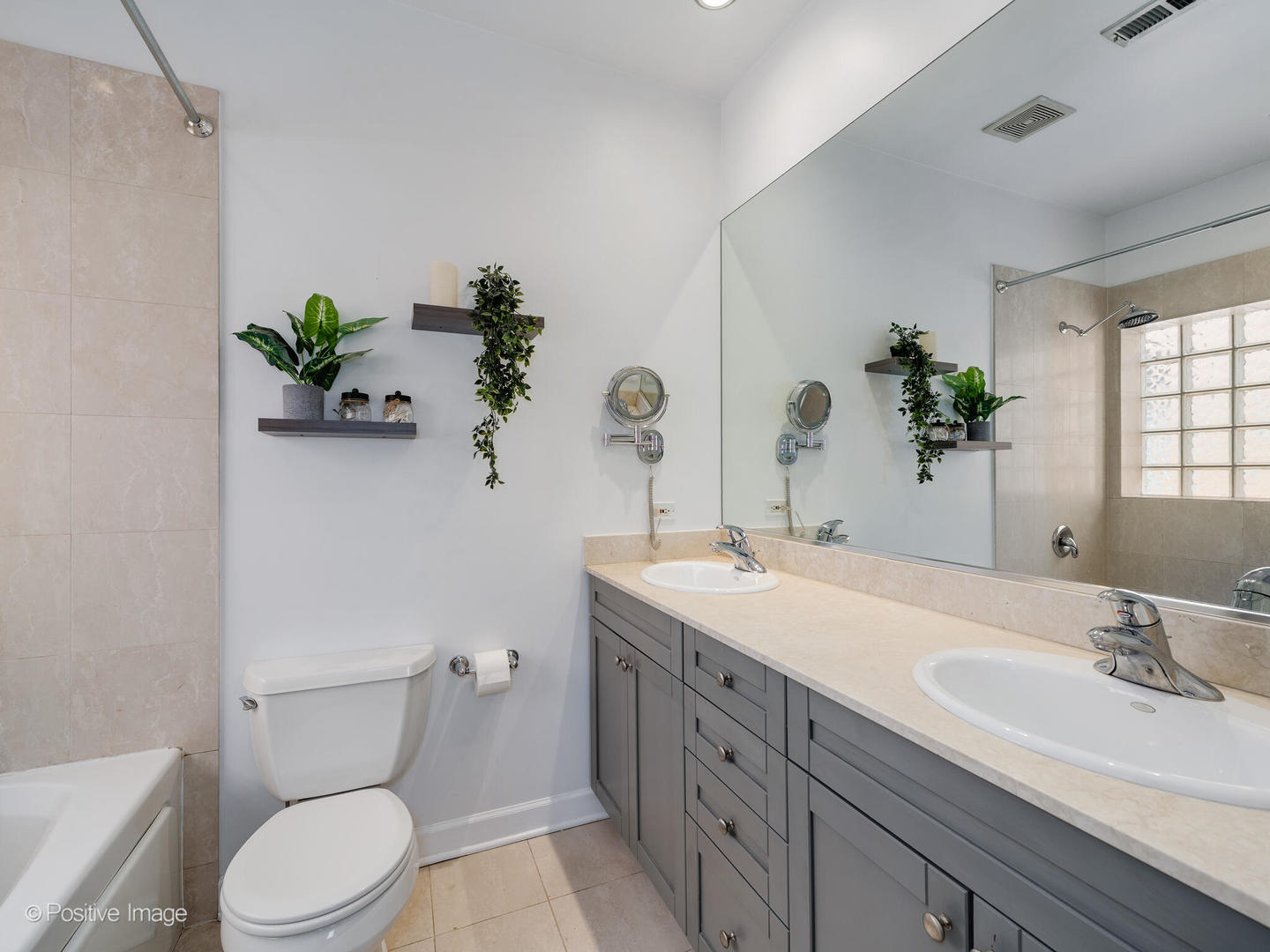 2938 North Damen Avenue, Unit 3 Chicago, IL 60618 - Photo 15 of 22 a bathroom with a granite countertop toilet a sink and a mirror