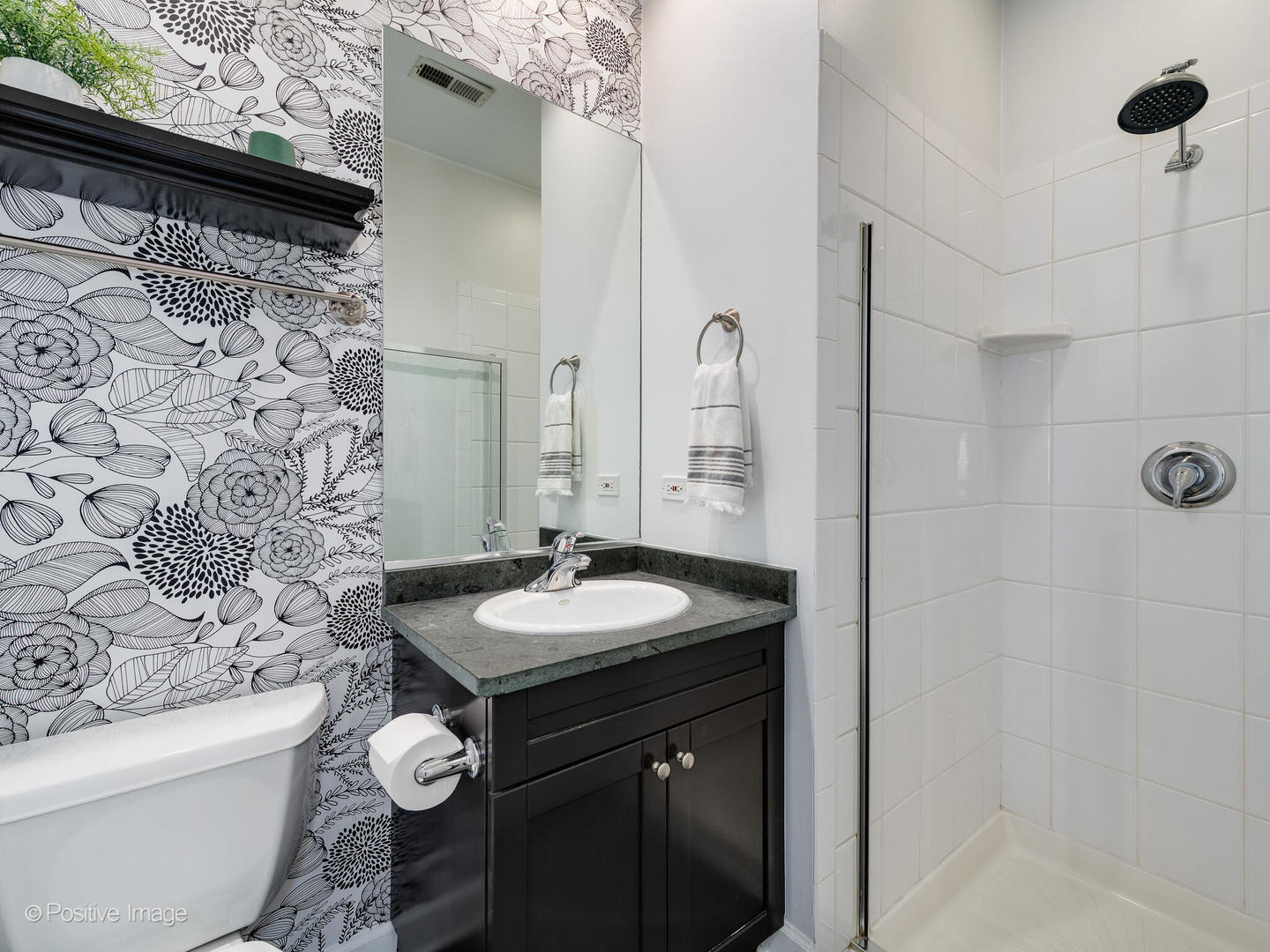 2938 North Damen Avenue, Unit 3 Chicago, IL 60618 - Photo 17 of 22 a bathroom with a sink and a mirror