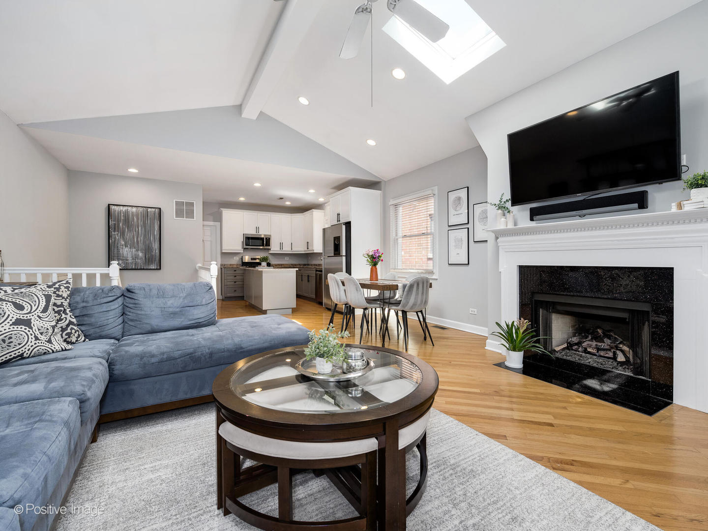 2938 North Damen Avenue, Unit 3 Chicago, IL 60618 - Photo 7 of 22 a living room with furniture a flat screen tv and a fireplace