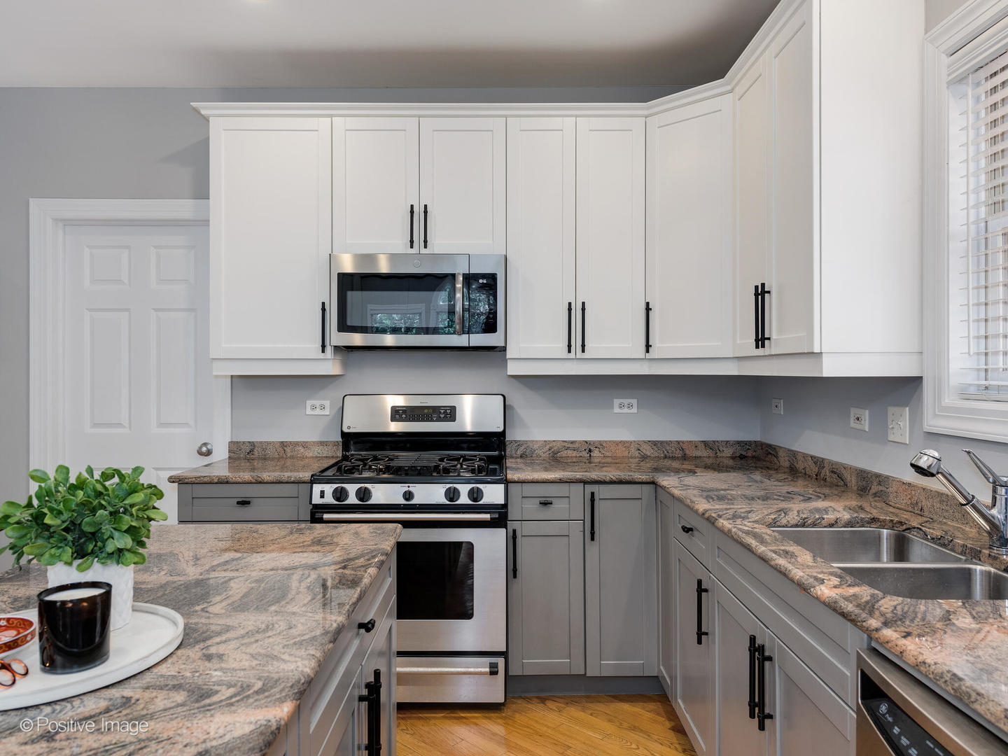2938 North Damen Avenue, Unit 3 Chicago, IL 60618 - Photo 10 of 22 a kitchen with granite countertop a sink a stove and cabinets
