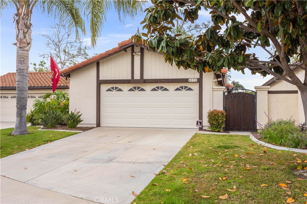 4773 Sequoia Place Oceanside, CA 92057 - Photo 1 of 1 a front view of a house with a yard and garage