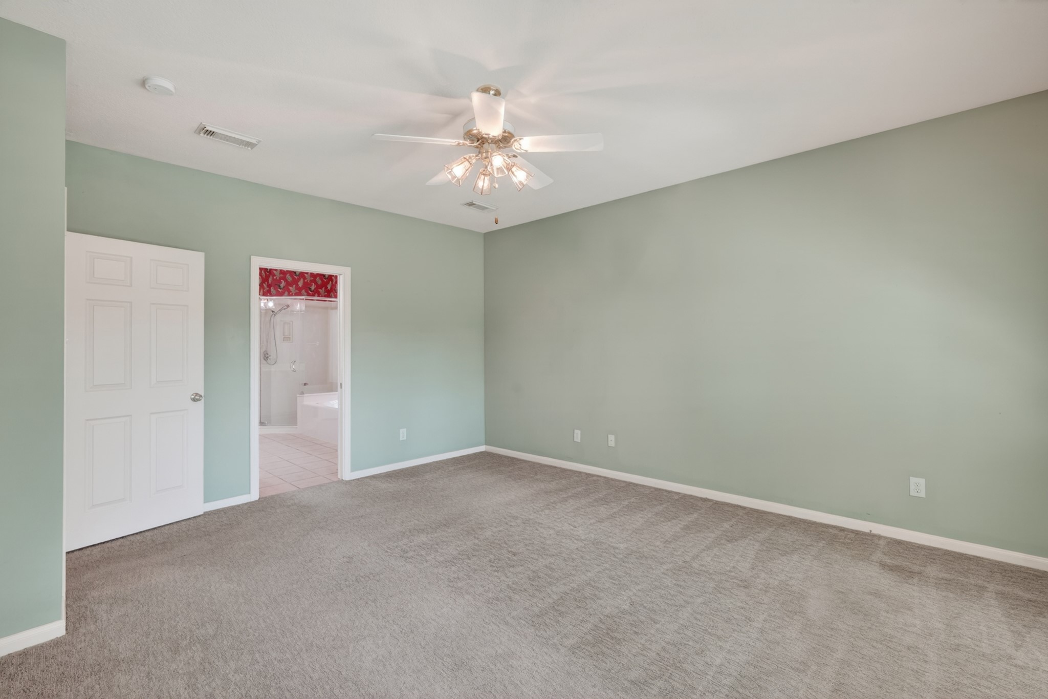 20714 Flora View Court Spring, TX 77379 - Photo 25 of 40 an empty room with a chandelier fan and windows