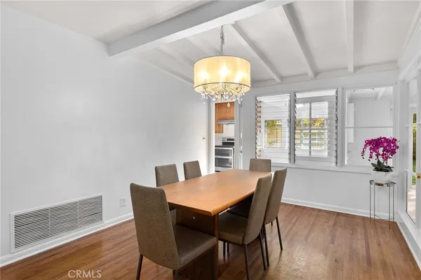 a view of a dining room with furniture wooden floor and chandelier