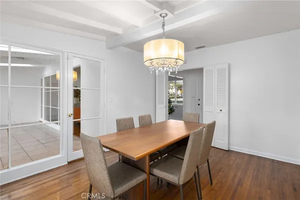a view of a dining room with furniture wooden floor and chandelier