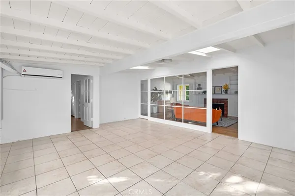 a view of an empty room and kitchen