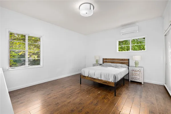 a bed sitting in a bedroom next to a window