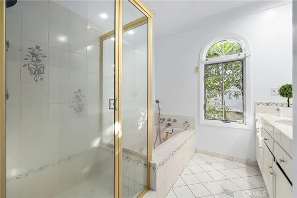 a bathroom with a sink a window and shower