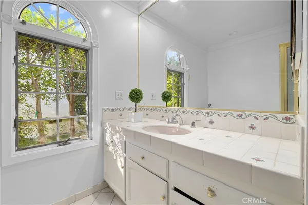 a bathroom with a sink and a large mirror