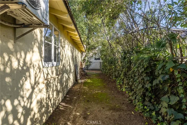 a view of a pathway of a house with a yard