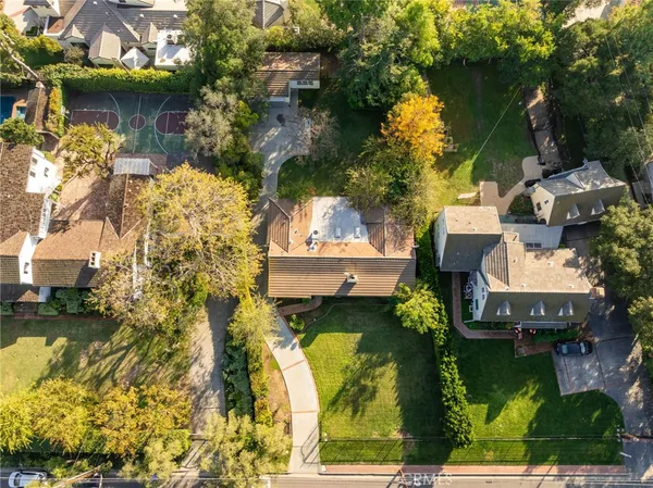 an aerial view of a house with a yard basket ball court and outdoor seating