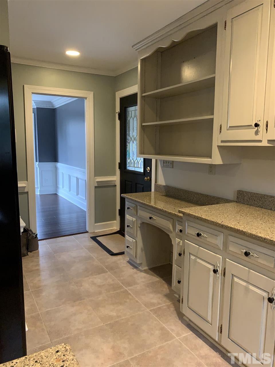 8800 Audley Circle Raleigh, NC 27615 - Photo 14 of 27 a kitchen with white cabinets and stainless steel appliances