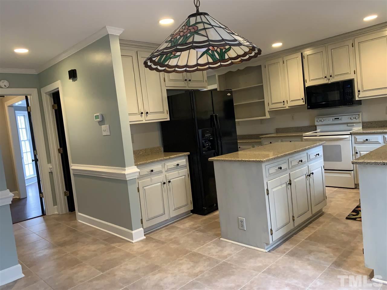 8800 Audley Circle Raleigh, NC 27615 - Photo 15 of 27 a kitchen with stainless steel appliances granite countertop a refrigerator a stove a sink and a microwave