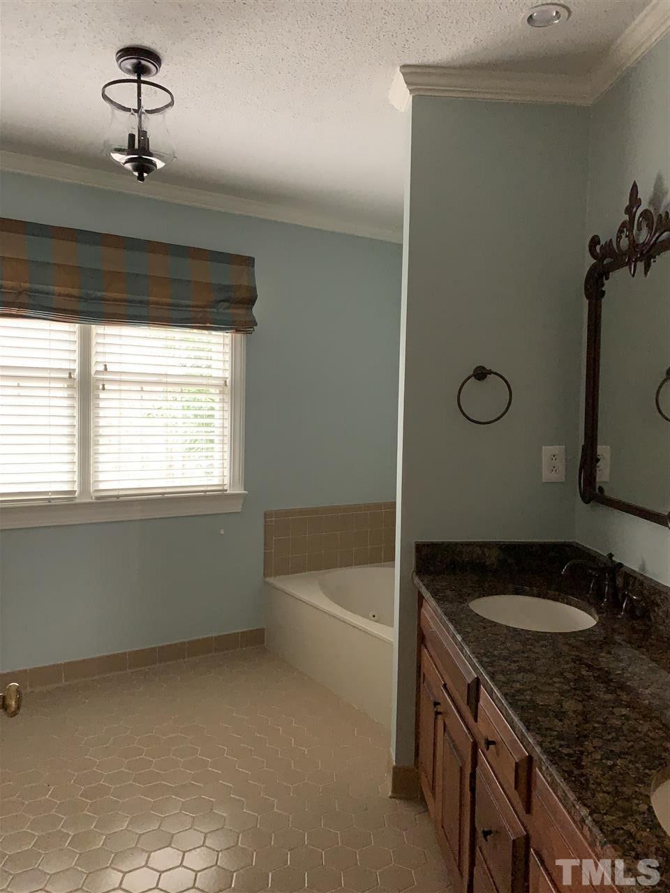 8800 Audley Circle Raleigh, NC 27615 - Photo 17 of 27 a bathroom with a granite countertop sink and a bathtub