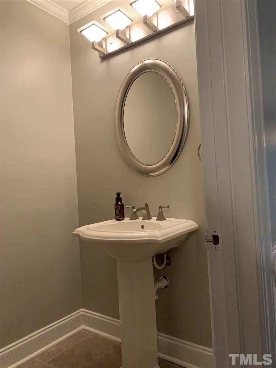 8800 Audley Circle Raleigh, NC 27615 - Photo 19 of 27 a bathroom with a sink and a mirror