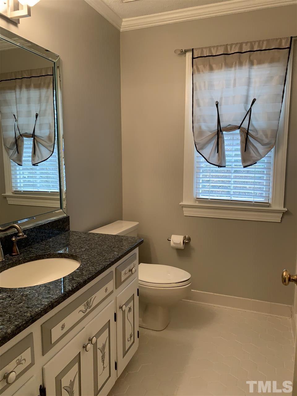 8800 Audley Circle Raleigh, NC 27615 - Photo 20 of 27 a bathroom with a granite countertop sink toilet and mirror