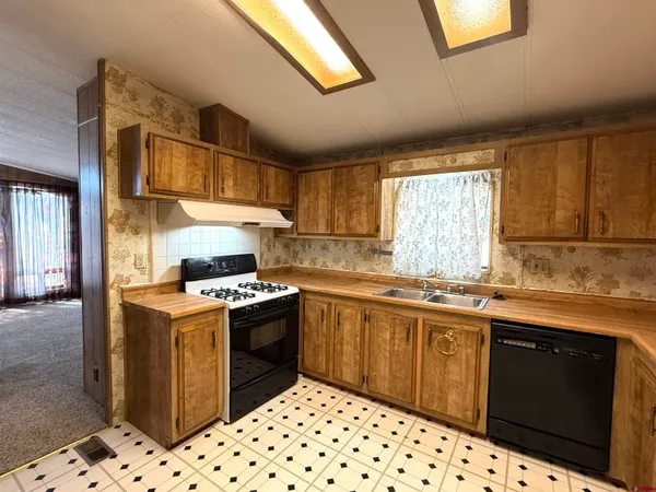 a kitchen with sink cabinets and window