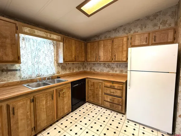 a kitchen with a refrigerator and a sink