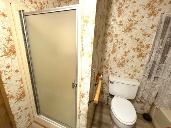 a bathroom with a granite countertop sink and a bathtub