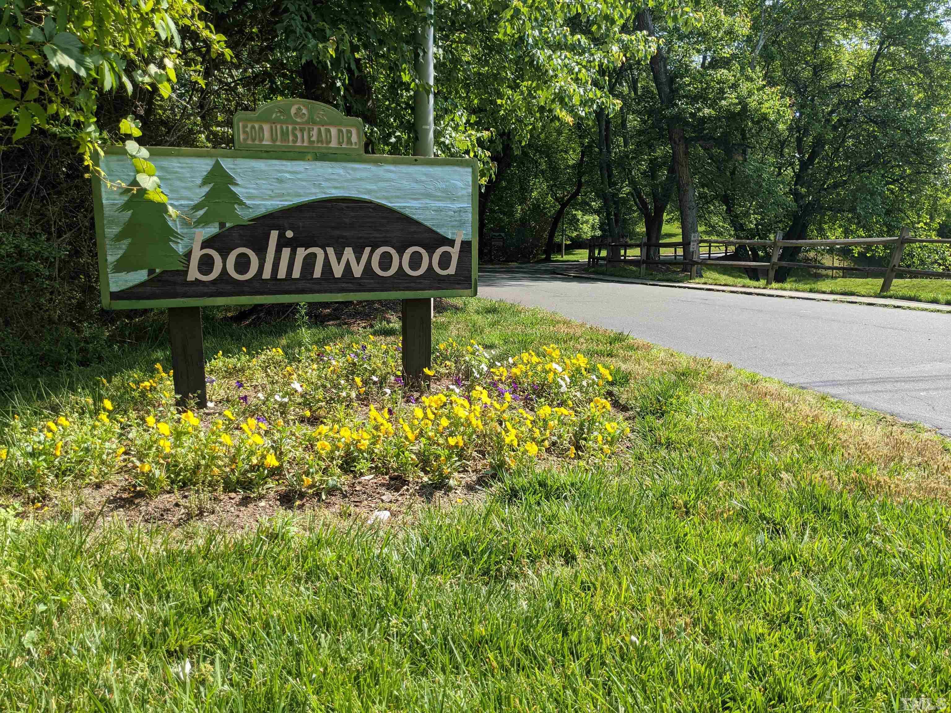 a view of sign board with large trees