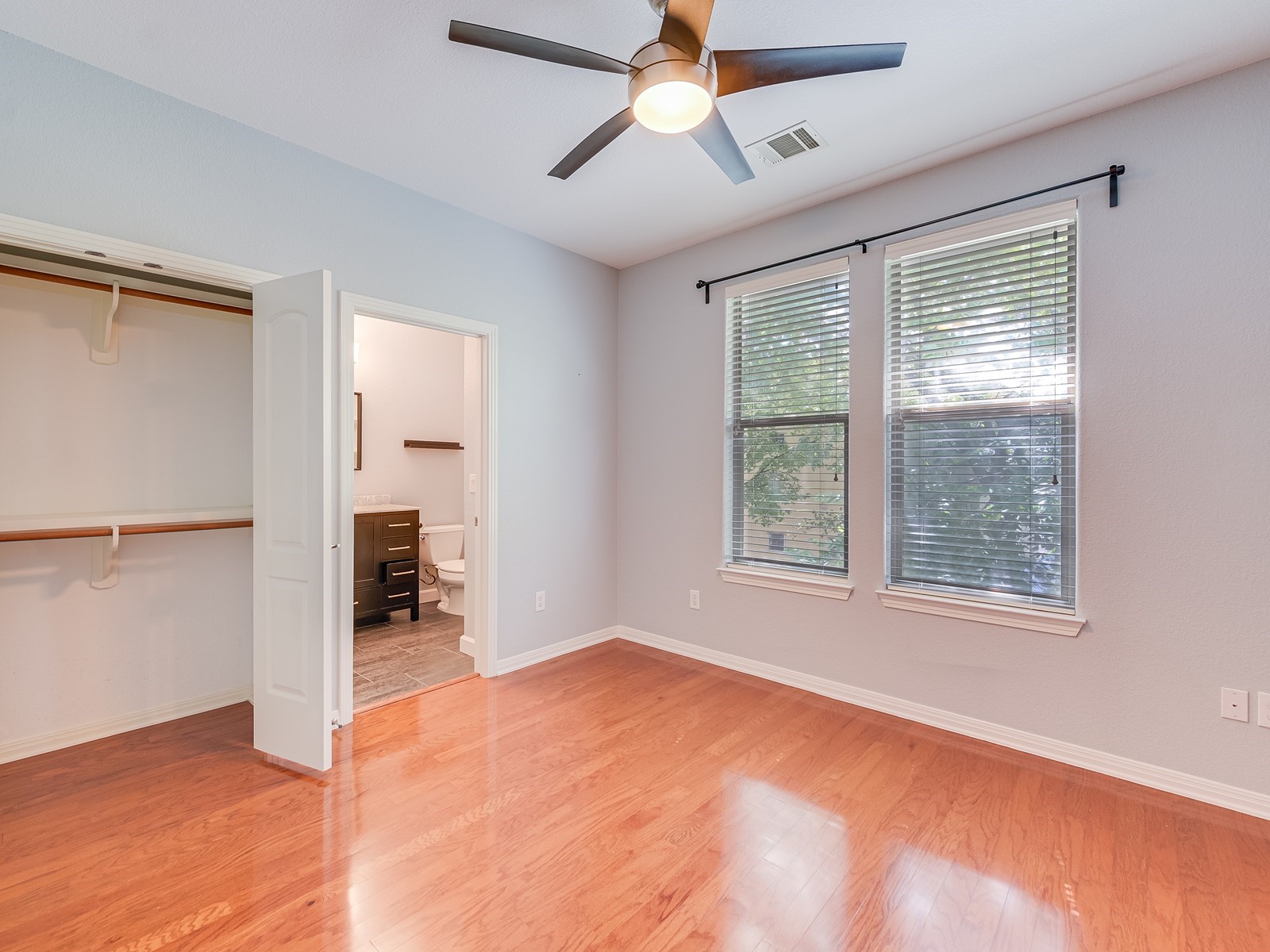 1115 Kinney Avenue, Unit 9 Austin, TX 78704 - Photo 11 of 19 Unfurnished bedroom featuring light wood-style floors, a closet, visible vents, and baseboards